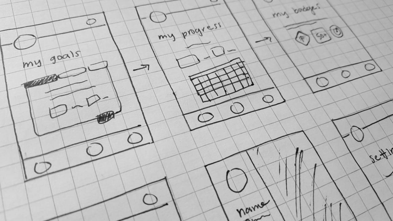 black and white computer piece of paper with sketched app screen ideas drawn on it